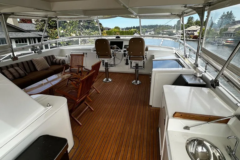 Slide: The Image of Cockpit of 2001 Rayburn Flush Deck yacht with navigation screens and wooden steering wheel. - 20