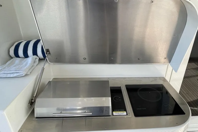 Slide: The Image of Luxurious 2001 Rayburn Flush Deck yacht bedroom with elegant wood furnishings and ambient lighting. - 25