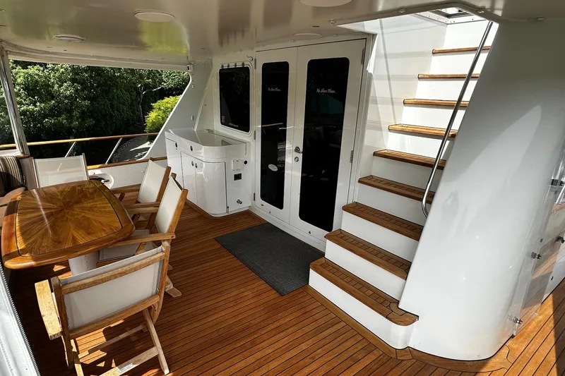 Slide: The Image of Luxurious 2001 Rayburn Flush Deck yacht bedroom with elegant wood paneling and modern amenities. - 26