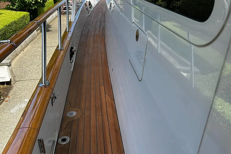 Slide: The Image of Luxurious wood-paneled bedroom in 2001 Rayburn Flush Deck yacht, featuring cozy bedding and elegant lighting. - 35