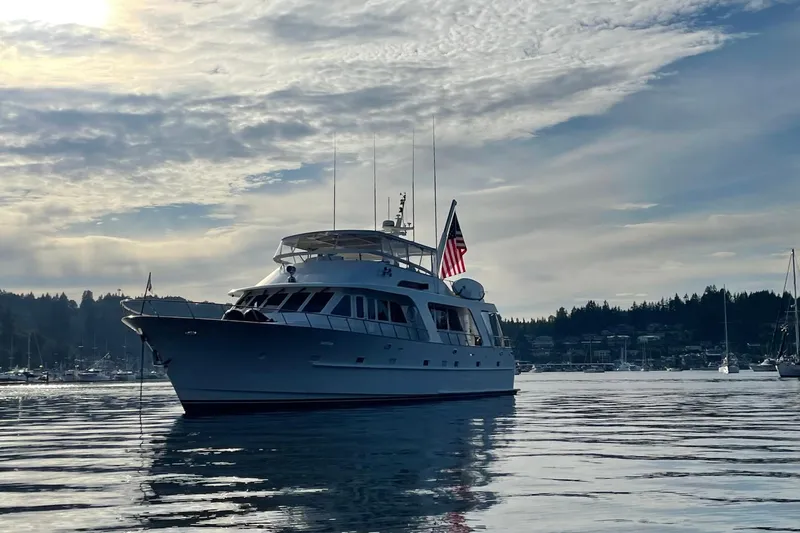 Slide: The Image of Luxurious 2001 Rayburn Flush Deck yacht with elegant outdoor seating and scenic lake view. - 53