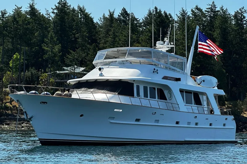 Slide: The Image of Luxurious 2001 Rayburn Flush Deck yacht with elegant outdoor dining area and scenic waterfront view. - 54