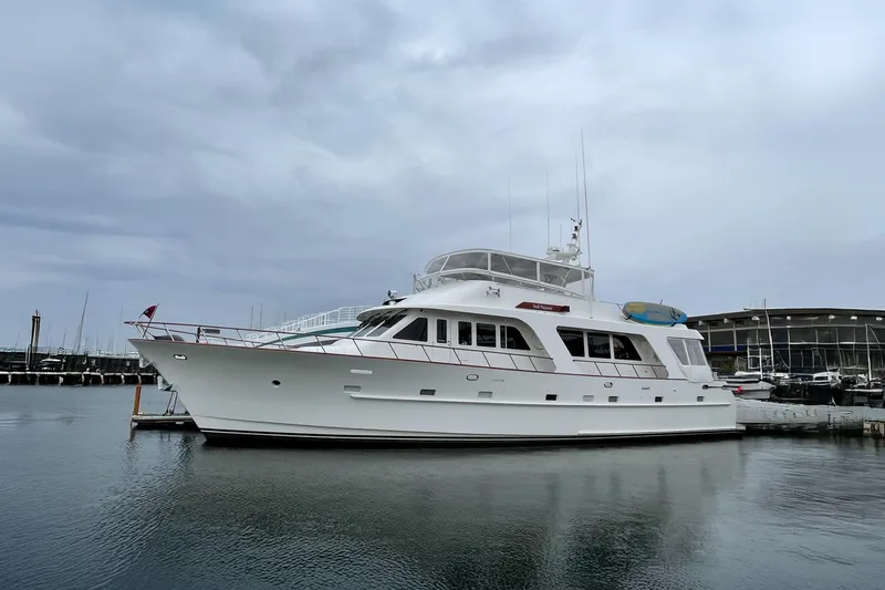 Slide: The Image of Elegant dining setup on 2001 Rayburn Flush Deck yacht, featuring tableware and cushioned seating. - 55