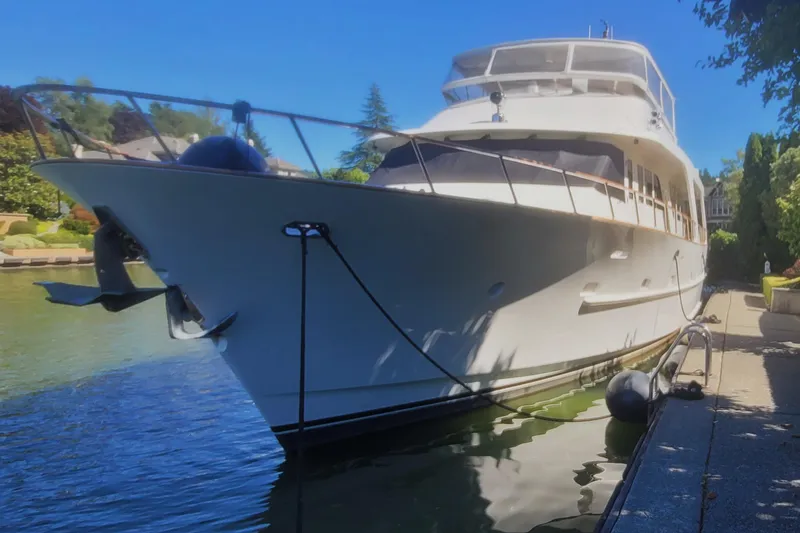 Slide: The Image of 2001 Rayburn Flush Deck yacht on serene lake with lush green shoreline. - 58