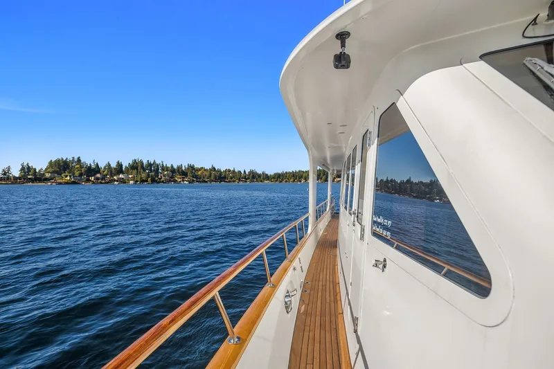 Slide: The Image of Side deck view of 2001 Rayburn Flush Deck yacht on a scenic lake. - 61