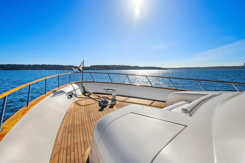 Slide: The Image of 2001 Rayburn Flush Deck yacht cruising on a serene lake with clear blue skies. - 63