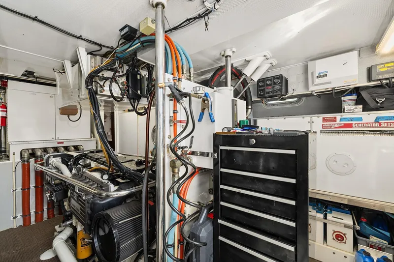 Slide: The Image of Rayburn Flush Deck 2001 yacht with turtle design, docked by scenic waterfront homes. - 67