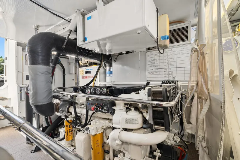 Slide: The Image of Engine room of 2001 Rayburn Flush Deck yacht with mechanical equipment and storage cabinets. - 69