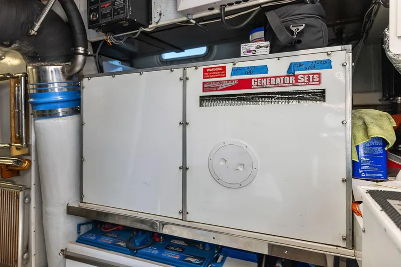 Slide: The Image of Engine room of 2001 Rayburn Flush Deck yacht, featuring advanced machinery and equipment. - 71