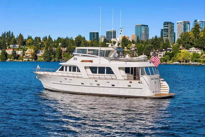 Slide: The Image of 2001 Rayburn Flush Deck yacht cruising on calm waters with city skyline backdrop. - 79