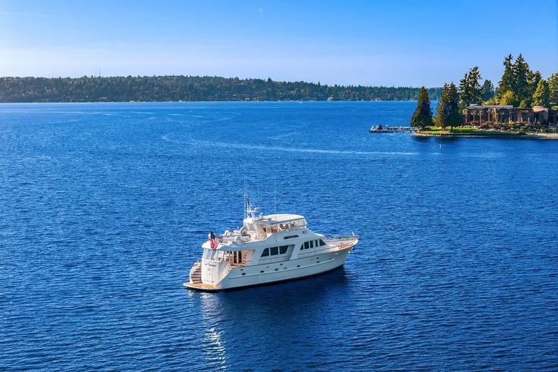 Slide: The Image of Luxury 2001 Rayburn Flush Deck yacht with American flag and tender on deck. - 87