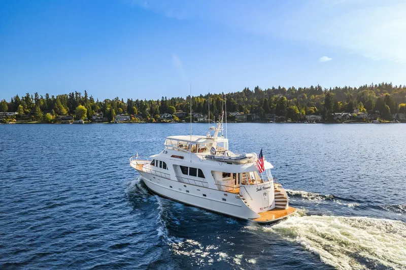 Slide: The Image of 2001 Rayburn Flush Deck yacht cruising on a clear blue lake under a sunny sky. - 93