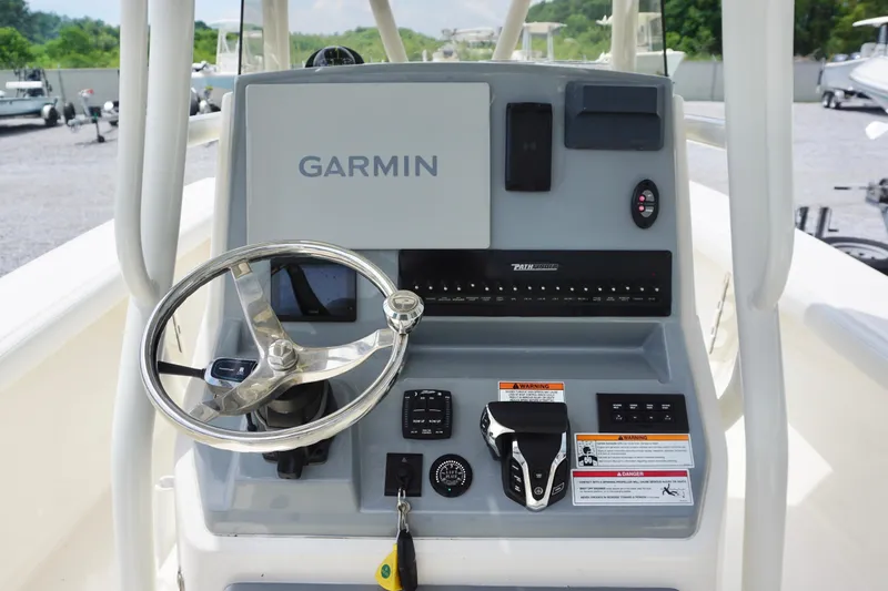 Slide: The Image of 2024 Pathfinder 2700 Open boat console with Garmin navigation system and steering wheel. - 11