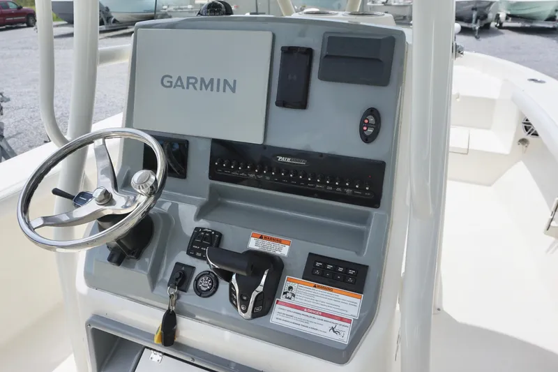 Slide: The Image of 2024 Pathfinder 2700 Open boat console with Garmin navigation system and steering wheel. - 13