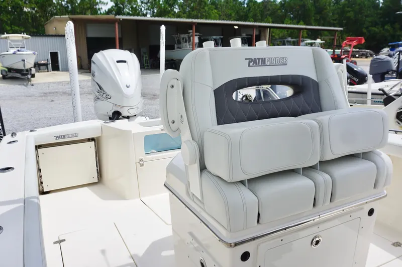 Slide: The Image of 2024 Pathfinder 2700 Open boat interior with cushioned seating and outboard motor. - 14