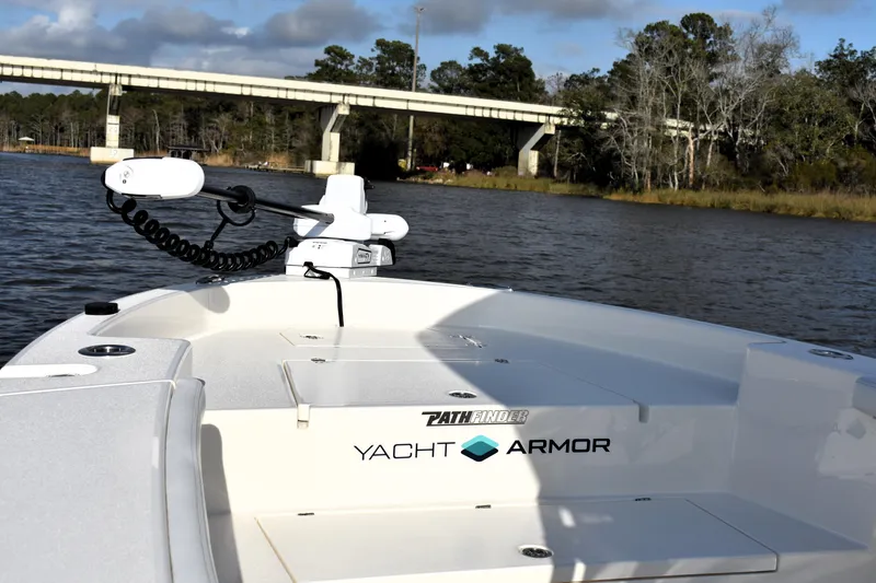Slide: The Image of 2024 Pathfinder 2700 Open boat on water near a bridge, featuring Yacht Armor branding. - 19