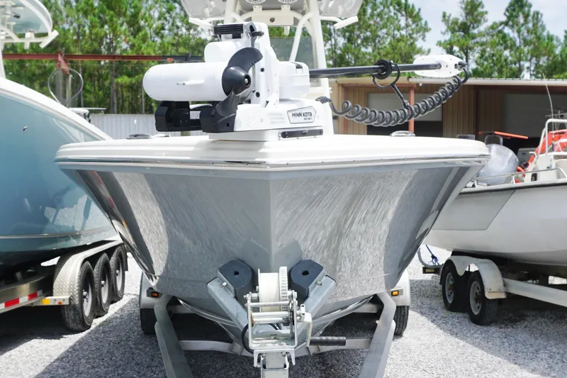 Slide: The Image of 2024 Pathfinder 2700 Open boat on trailer, featuring Minn Kota motor, parked outdoors. - 3