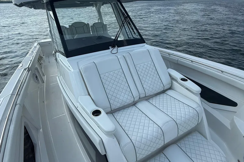 Slide: The Image of 2022 Pursuit S 378 Sport boat with luxurious seating on calm water. - 11