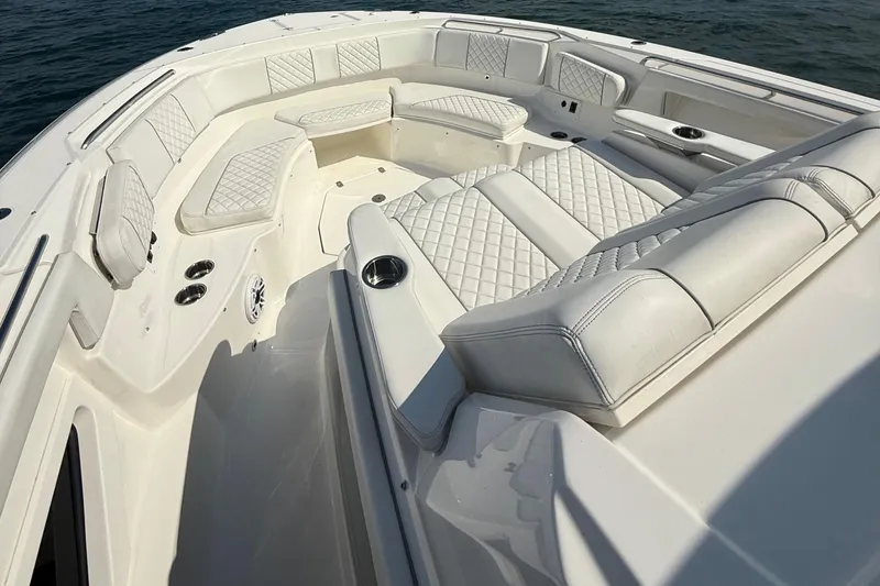 Slide: The Image of Luxurious seating on 2022 Pursuit S 378 Sport boat, featuring elegant white upholstery. - 14