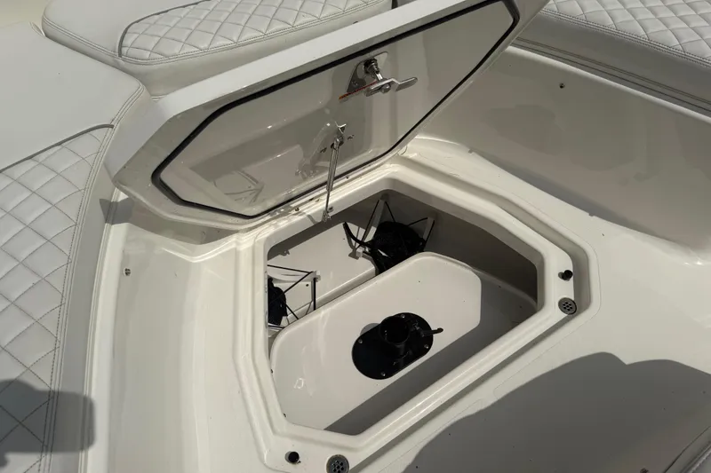 Slide: The Image of Open storage compartment on 2022 Pursuit S 378 Sport boat with quilted seating. - 17