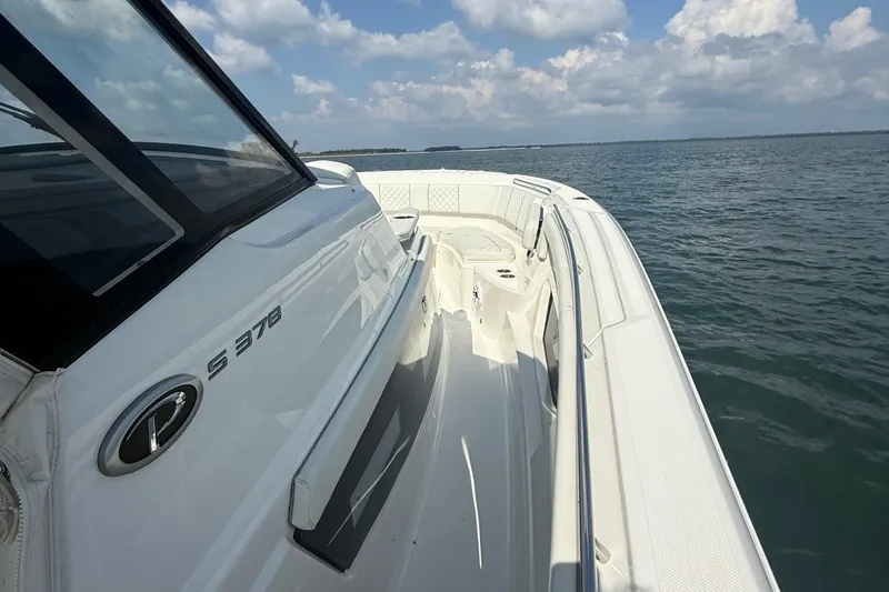 Slide: The Image of 2022 Pursuit S 378 Sport boat on open water under a cloudy sky. - 20