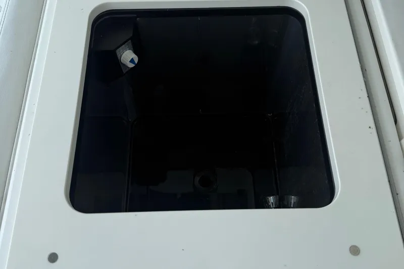 Slide: The Image of Open storage compartment on 2022 Pursuit S 378 Sport boat. - 26