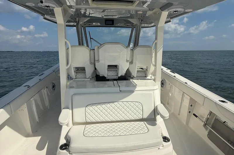 Slide: The Image of 2022 Pursuit S 378 Sport boat interior with white seating, ocean view. - 30