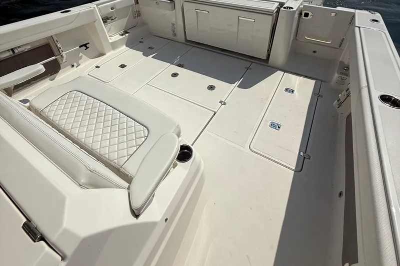 Slide: The Image of 2022 Pursuit S 378 Sport boat deck with cushioned seating and storage compartments. - 32