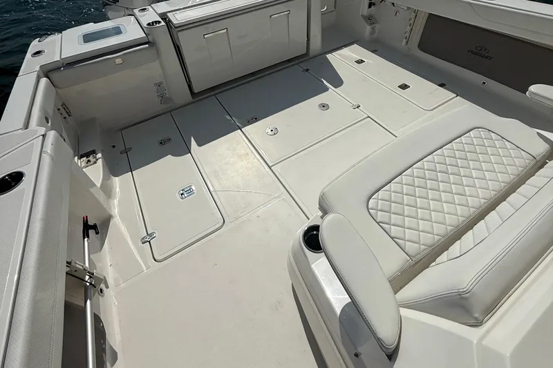 Slide: The Image of 2022 Pursuit S 378 Sport boat interior with cushioned seating and storage compartments. - 33