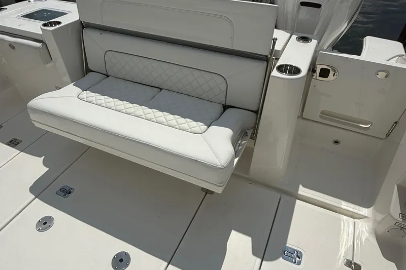 Slide: The Image of 2022 Pursuit S 378 Sport boat with white cushioned seating and cup holders. - 34