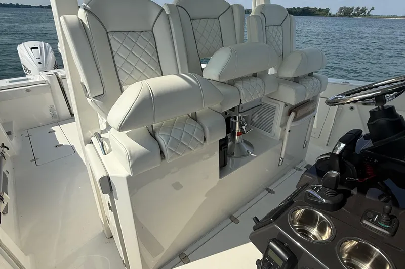 Slide: The Image of 2022 Pursuit S 378 Sport boat interior with luxurious seating and modern controls. - 36