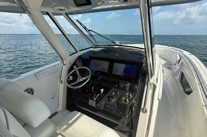 Slide: The Image of 2022 Pursuit S 378 Sport boat interior with advanced navigation system on open water. - 40