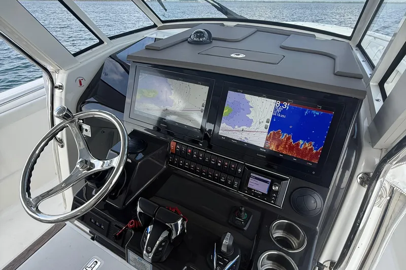 Slide: The Image of 2022 Pursuit S 378 Sport boat dashboard with navigation screens and steering wheel. - 41