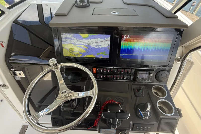 Slide: The Image of 2022 Pursuit S 378 Sport boat dashboard with dual Garmin displays and steering wheel. - 43