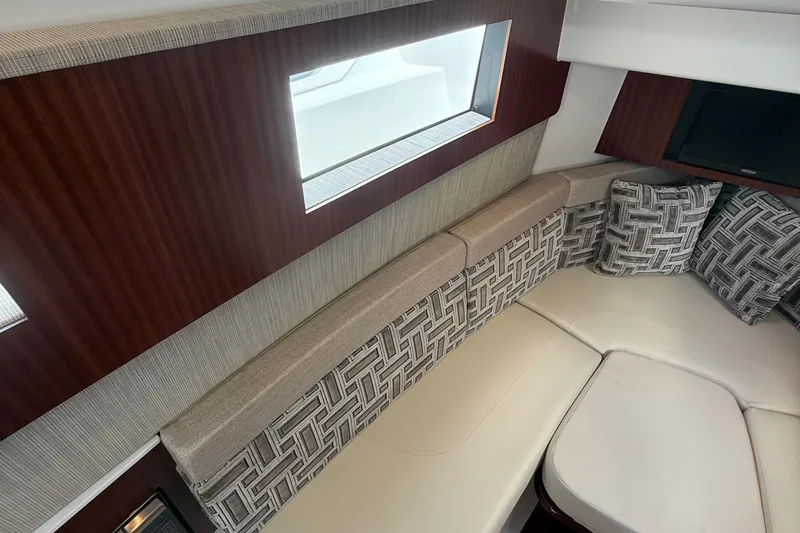 Slide: The Image of Interior of 2022 Pursuit S 378 Sport boat with cushioned seating and windows. - 49