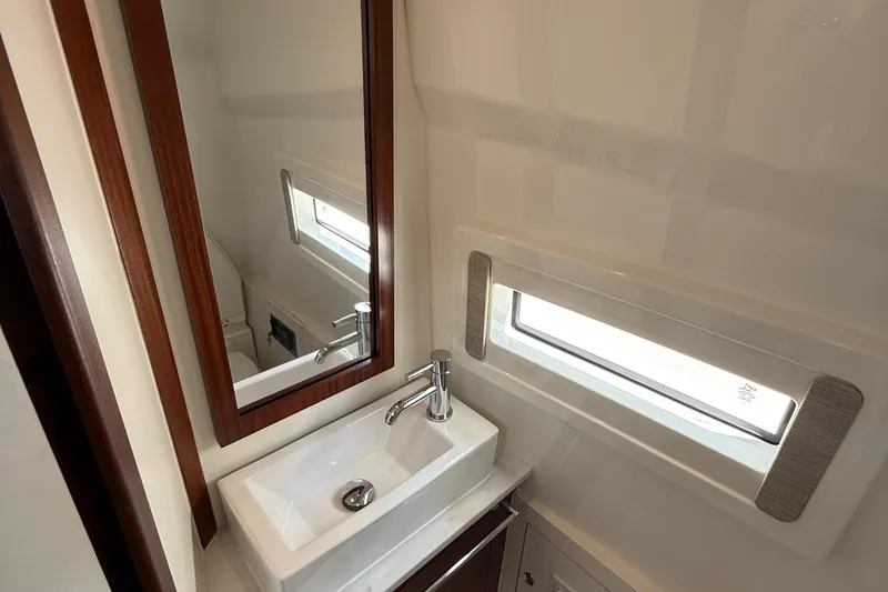 Slide: The Image of 2022 Pursuit S 378 Sport boat bathroom with modern sink and mirror. - 58