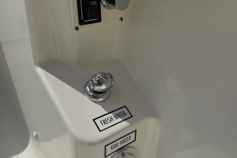 Slide: The Image of 2022 Pursuit S 378 Sport boat water controls, featuring fresh and raw water options. - 59
