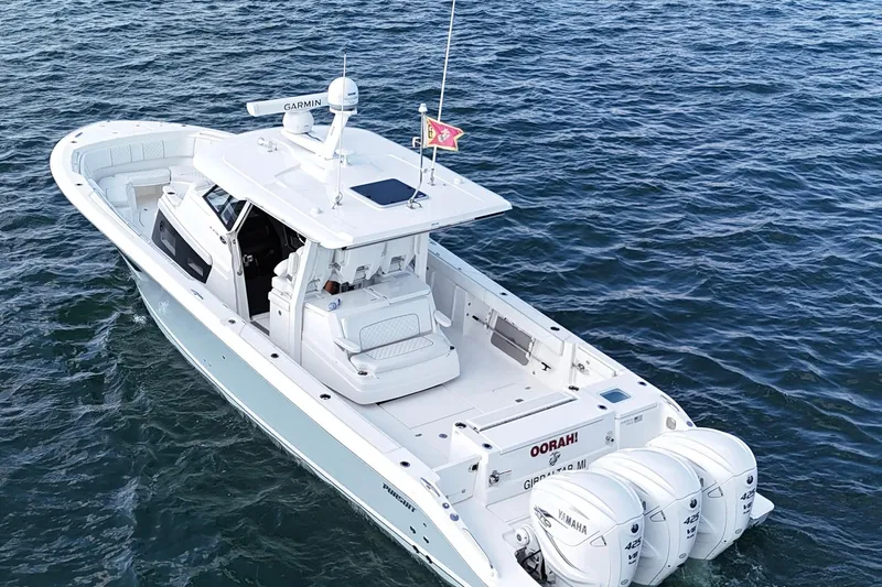 Slide: The Image of 2022 Pursuit S 378 Sport boat on open water, featuring triple Yamaha engines. - 6