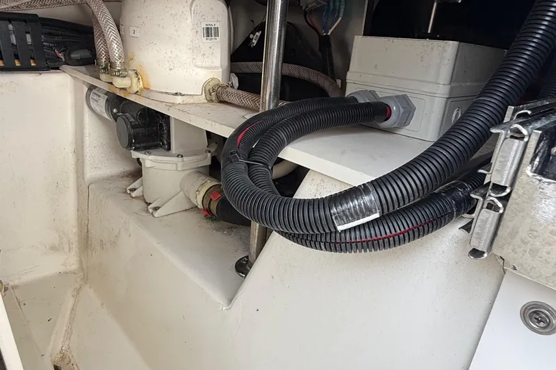 Slide: The Image of 2022 Pursuit S 378 Sport boat engine compartment with hoses and wiring. - 63