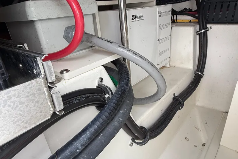 Slide: The Image of 2022 Pursuit S 378 Sport boat wiring and battery compartment with cables and connectors. - 64