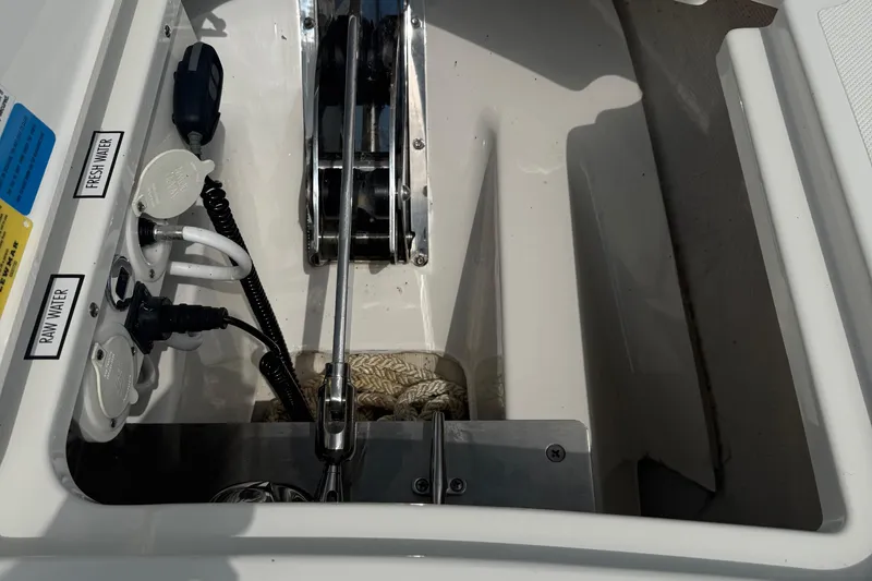 Slide: The Image of 2022 Pursuit S 378 Sport boat compartment with water connections and equipment. - 67