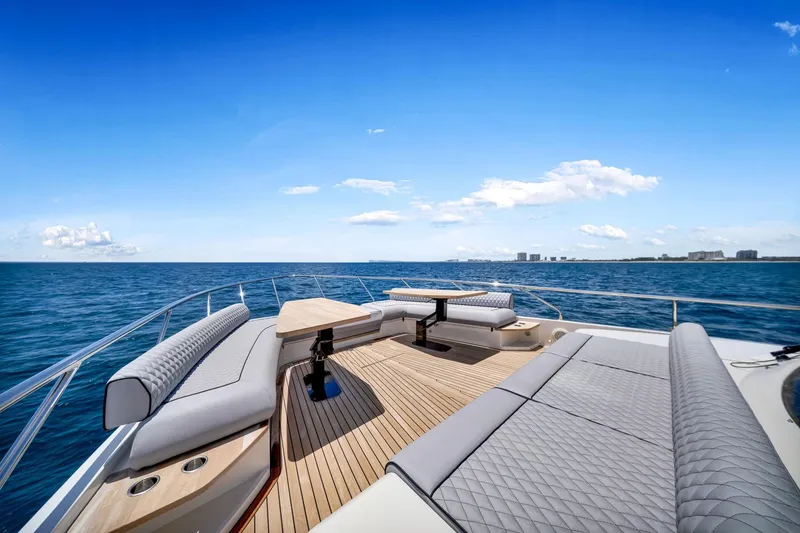 Slide: The Image of Luxurious 2022 Ferretti Yachts 670 deck with elegant seating, overlooking serene ocean view. - 10