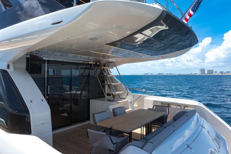 Slide: The Image of 2022 Ferretti Yachts 670, luxury deck view, ocean backdrop, modern design. - 23