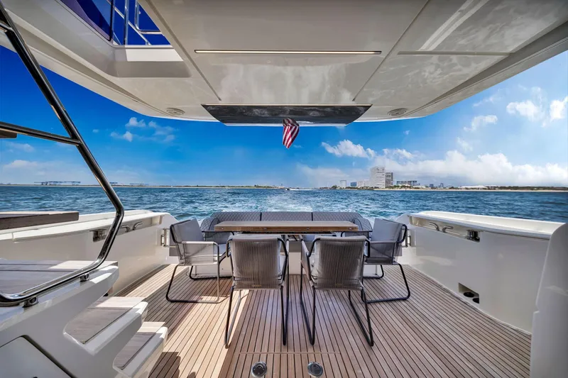 Slide: The Image of Luxurious 2022 Ferretti Yachts 670 deck with ocean view and dining area. - 24