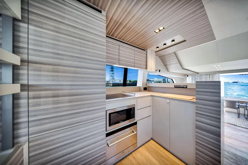 Slide: The Image of Modern kitchen interior of 2022 Ferretti Yachts 670, featuring sleek cabinetry and ocean view. - 33