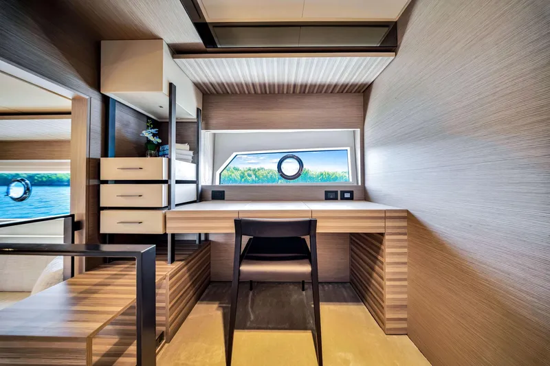 Slide: The Image of Luxurious interior of 2022 Ferretti Yachts 670 with modern desk and scenic window view. - 39