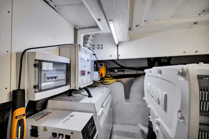 Slide: The Image of Engine room of 2022 Ferretti Yachts 670, featuring electrical panels and MAN engine components. - 63