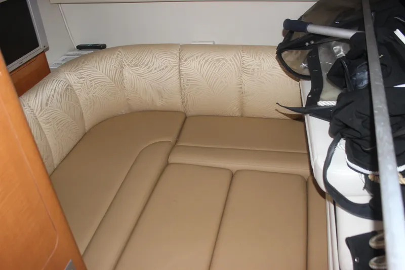 Slide: The Image of 2007 Chaparral Signature 310 interior with beige seating and storage area. - 12