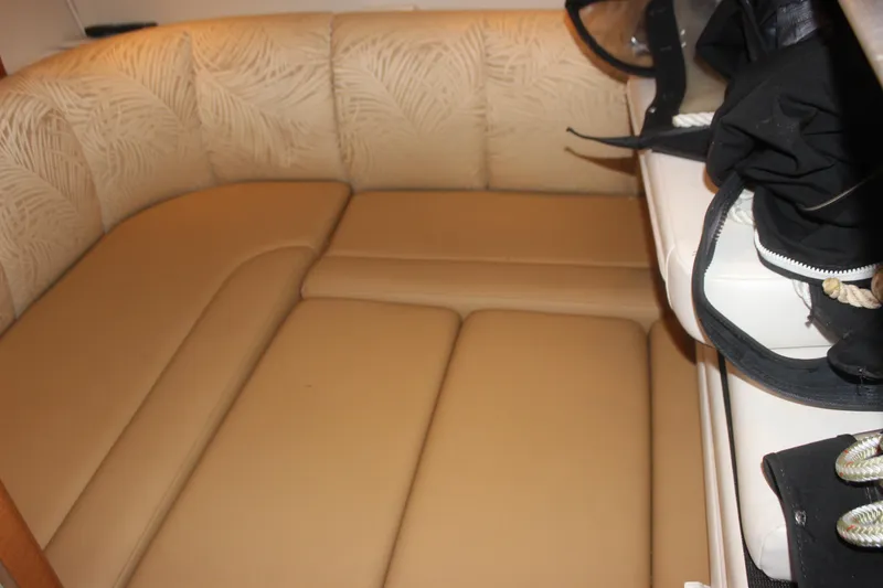 Slide: The Image of 2007 Chaparral Signature 310 interior with beige seating and storage area. - 15