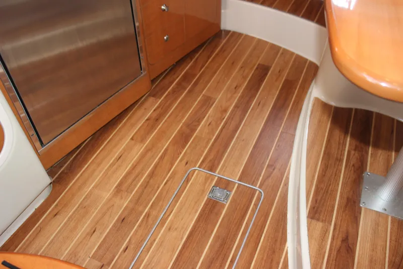 Slide: The Image of Wooden interior flooring of 2007 Chaparral Signature 310 boat cabin. - 17